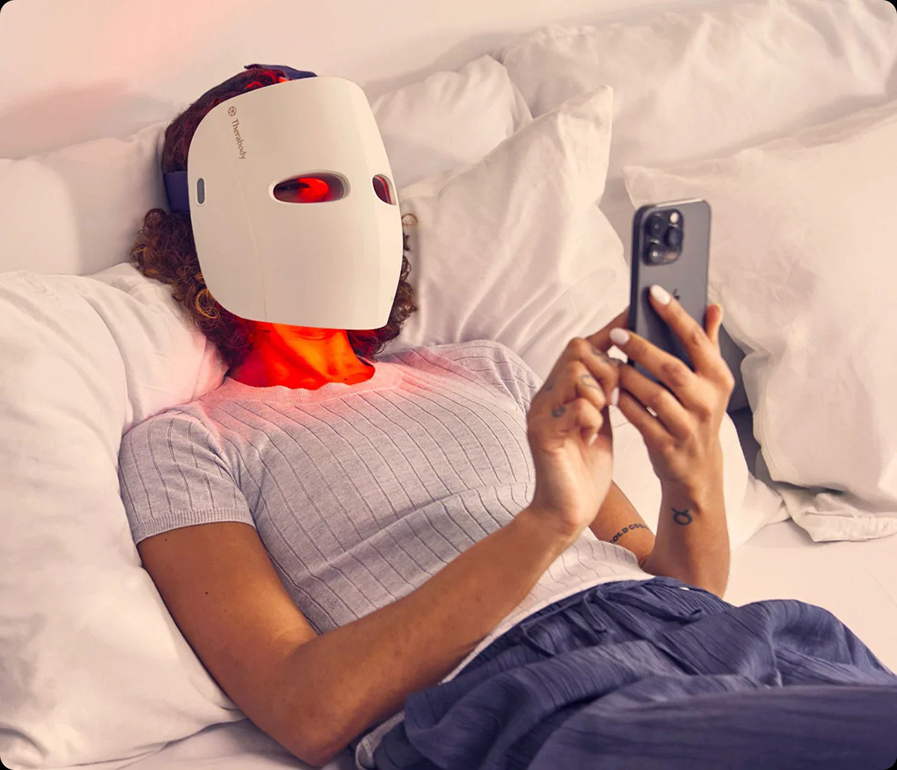 Woman Using the Therabody Therapy Mask While In Bed