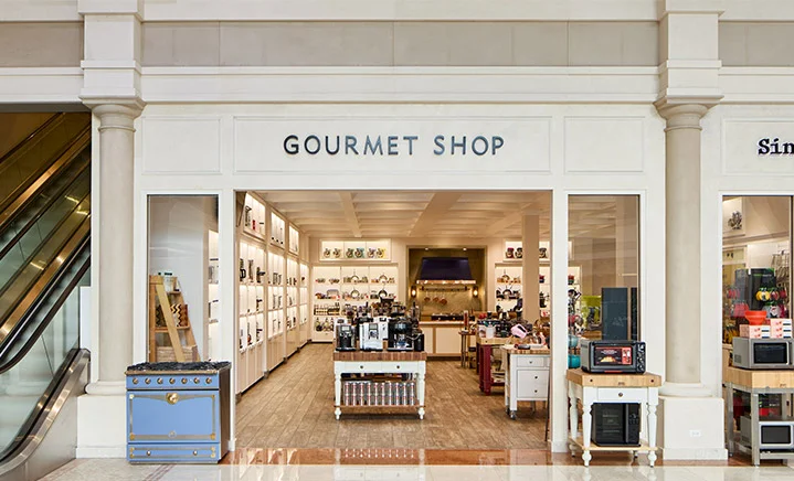 Gourmet shop in the Abt atrium featuring small kitchen appliances and a variety of gourmet food products.
