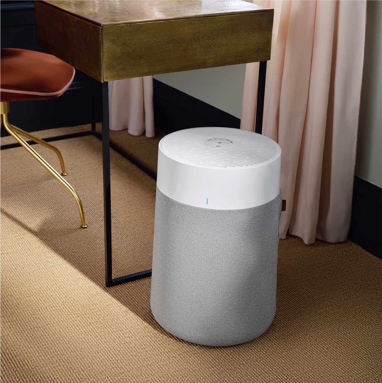 Blueair Air Purifier on the Floor near a Desk
