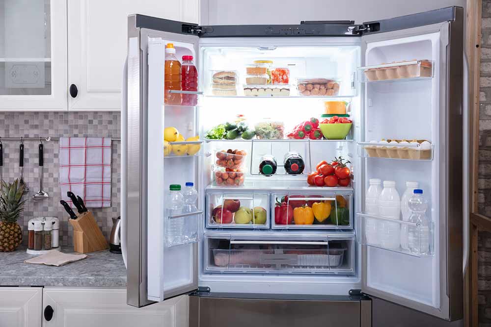 Open two-door refrigerator showing food