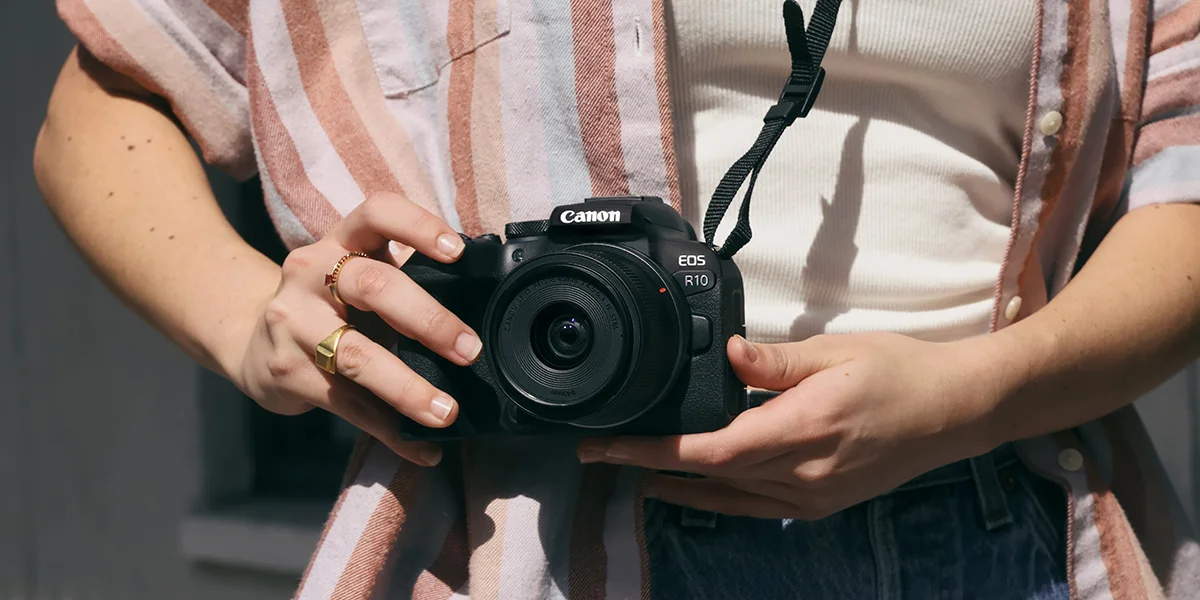 A shot of a photographer holding a Canon EOS camera