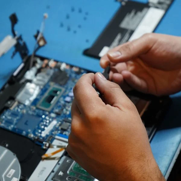 A closeup shot of a person holding a piece of computer hardware.