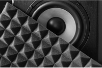 Close-up of soundproofing foam panel next to speaker for acoustic treatment