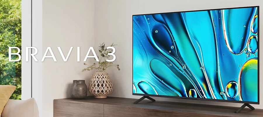 The Sony Bravia 3 TV sitting on a wooden TV stand displaying a textured blue image. To the left written over this image are the words "BRAVIA 3".