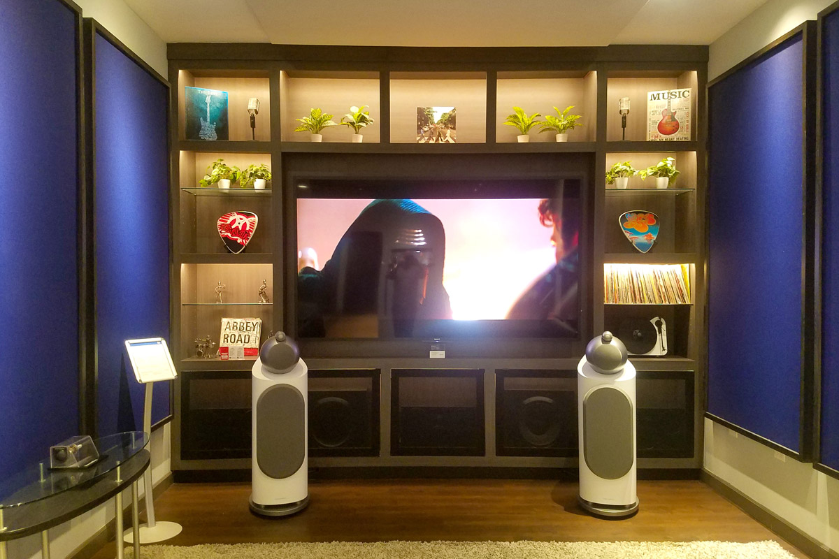 Bowers and Wilkins showroom displaying a home theater setup with a large flat screen TV and premium audio speakers