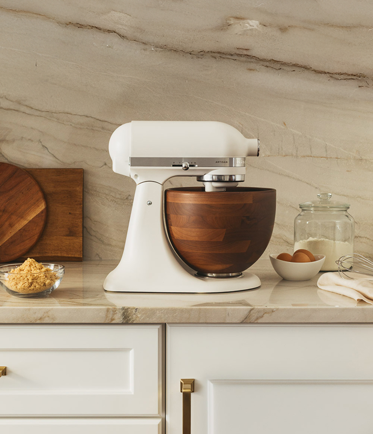 Close up glamour shot of a Breville smart oven air fryer on a countertop to the left of a range.