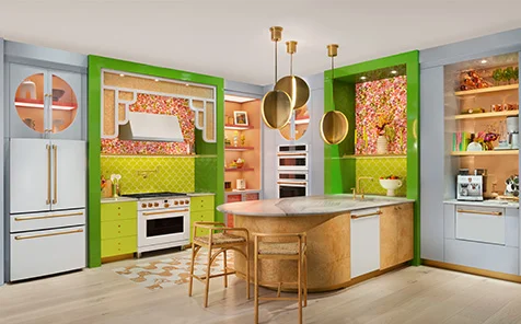 Wide shot of a vibrant and colorful kitchen with brass and copper accents with all cafe appliances