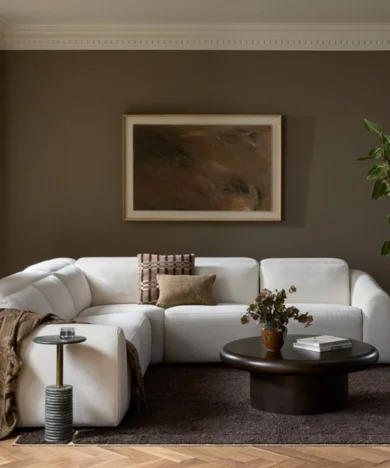 Contemporary living room furniture display featuring a light sofa and wood coffee table.