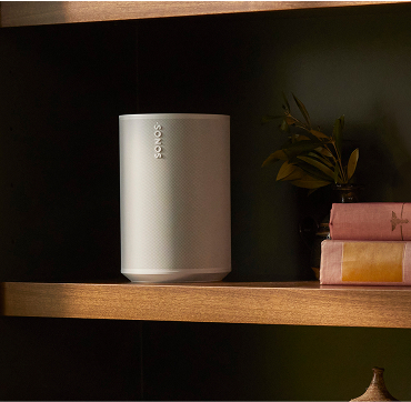 Close up shot of a Sonos portable speaker situated on a bookshelf