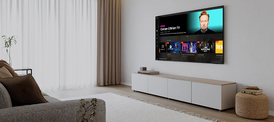 The Samsung DU8000 TV mounted on a living room wall displaying a streaming menu