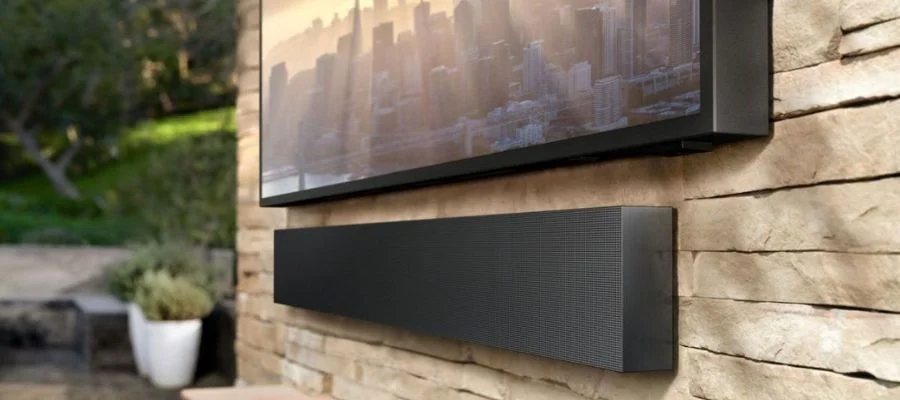 A close up of an outdoor TV and its outdoor soundbar