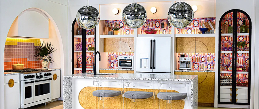 A colorful, patterned kitchen with Cafe appliances and disco balls