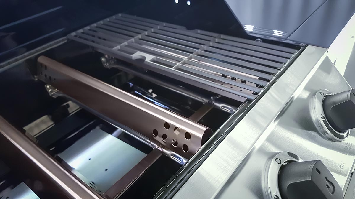 Close up of grill grates, burner tubes and parts