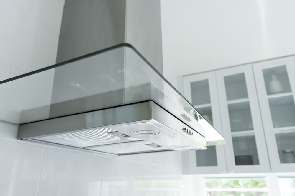 Range hood with cabinets in the background