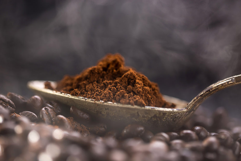 Close up of ground coffee and a spoon
