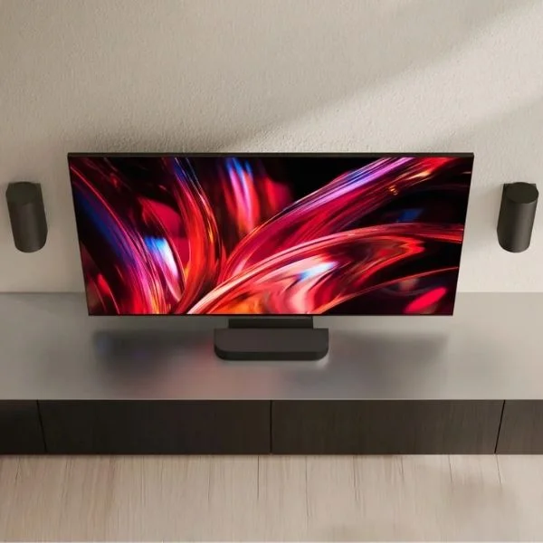 Sony Bravia Theater Trio speakers wall mounted next to a Sony TV with the bar underneath.