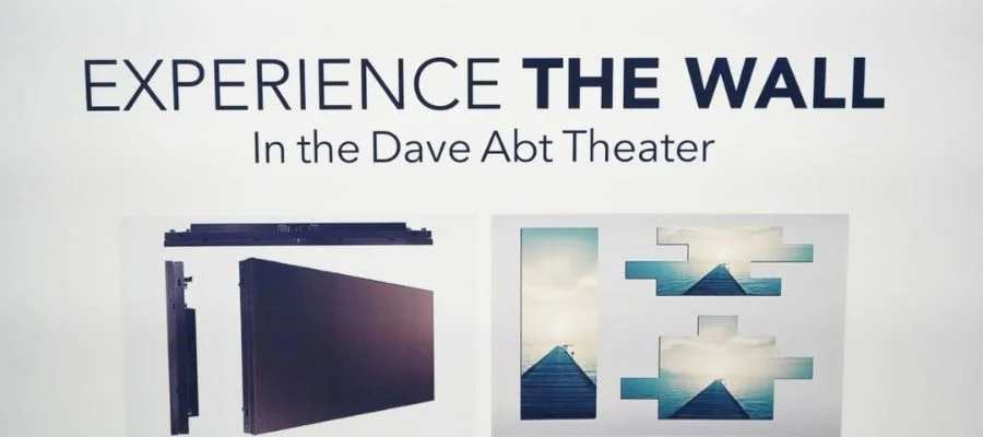 A poster displaying the phrase "Experience The Wall" In the Dave Abt Theater.