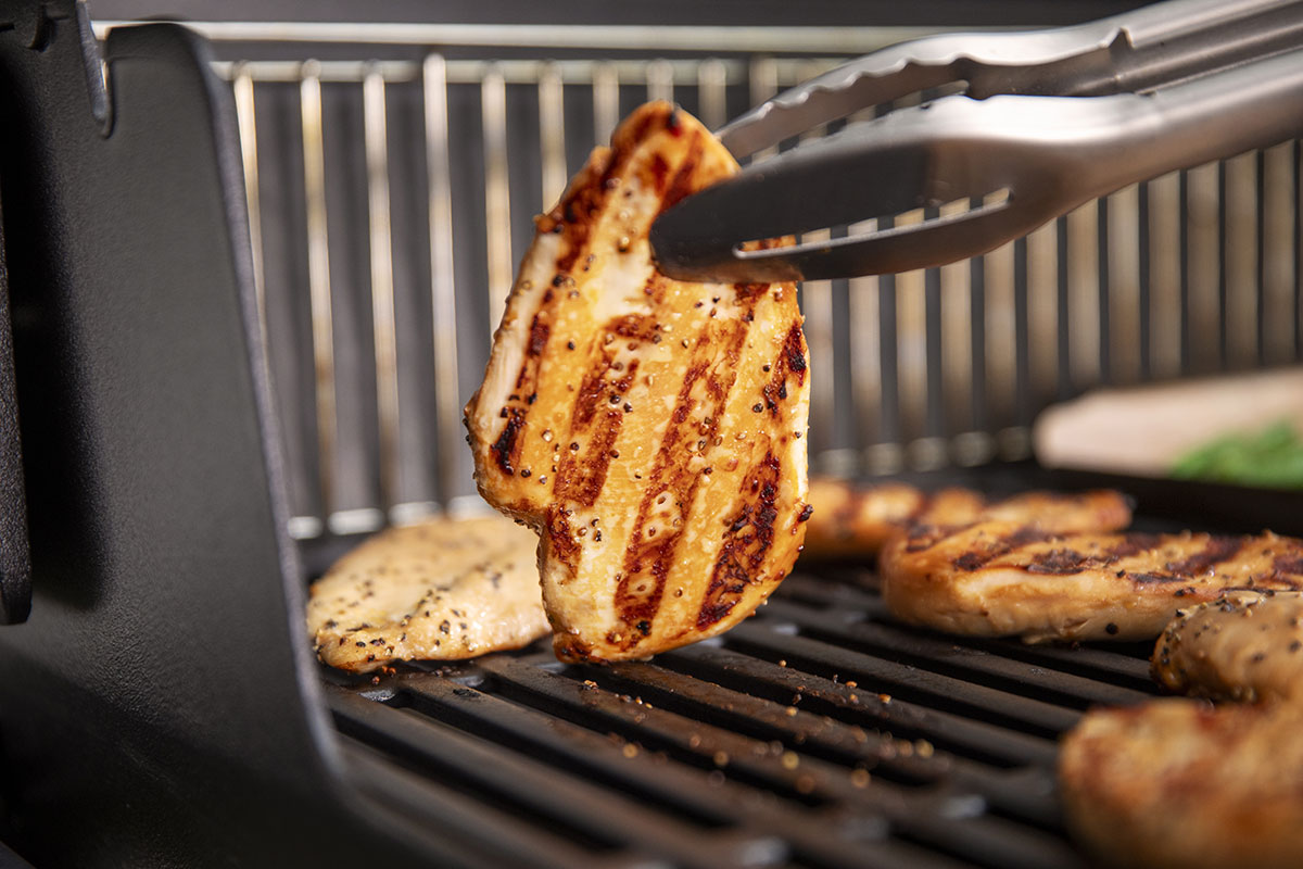 Cooked chicken being flipped over.