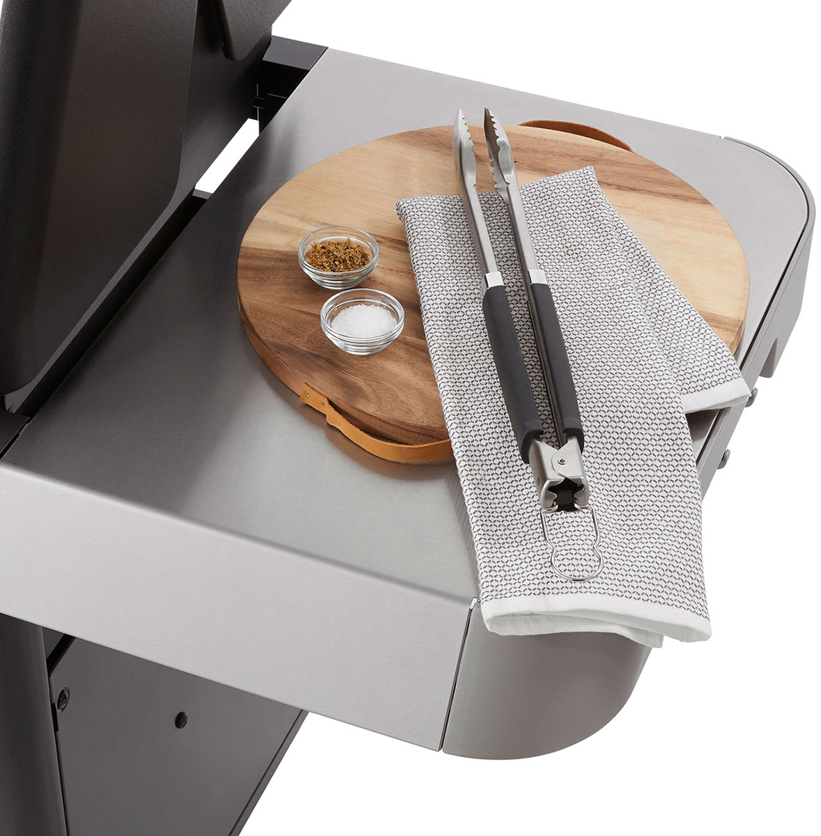 Weber Natural Gas Grill with Tools and Spices on Side Table
