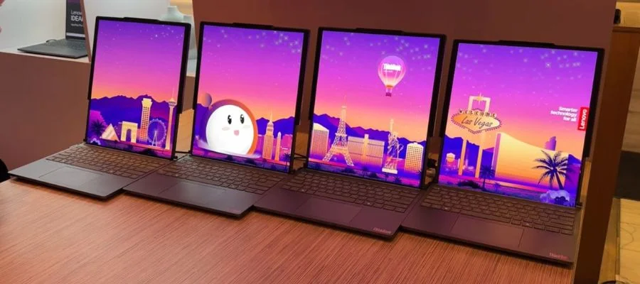 Three Lenovo ThinkBook Plus laptops open on a table