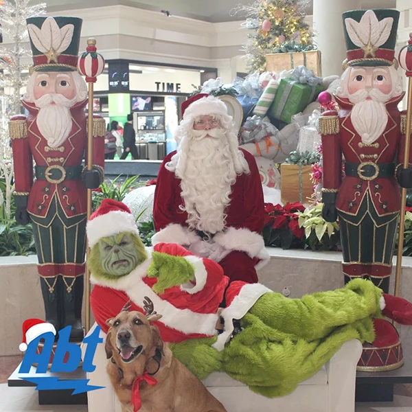 A photo of Santa, The Grinch and Max the dog.