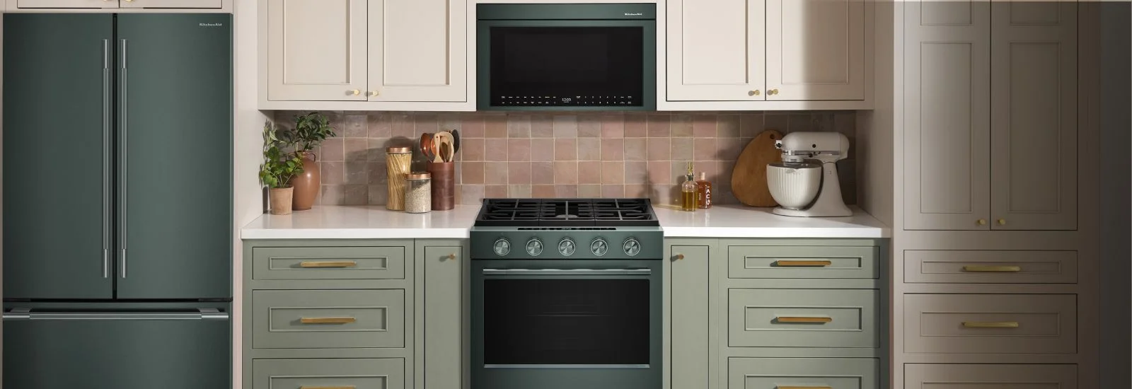 Stylized banner of a modern kitchen setting with all KitchenAid Juniper Appliances