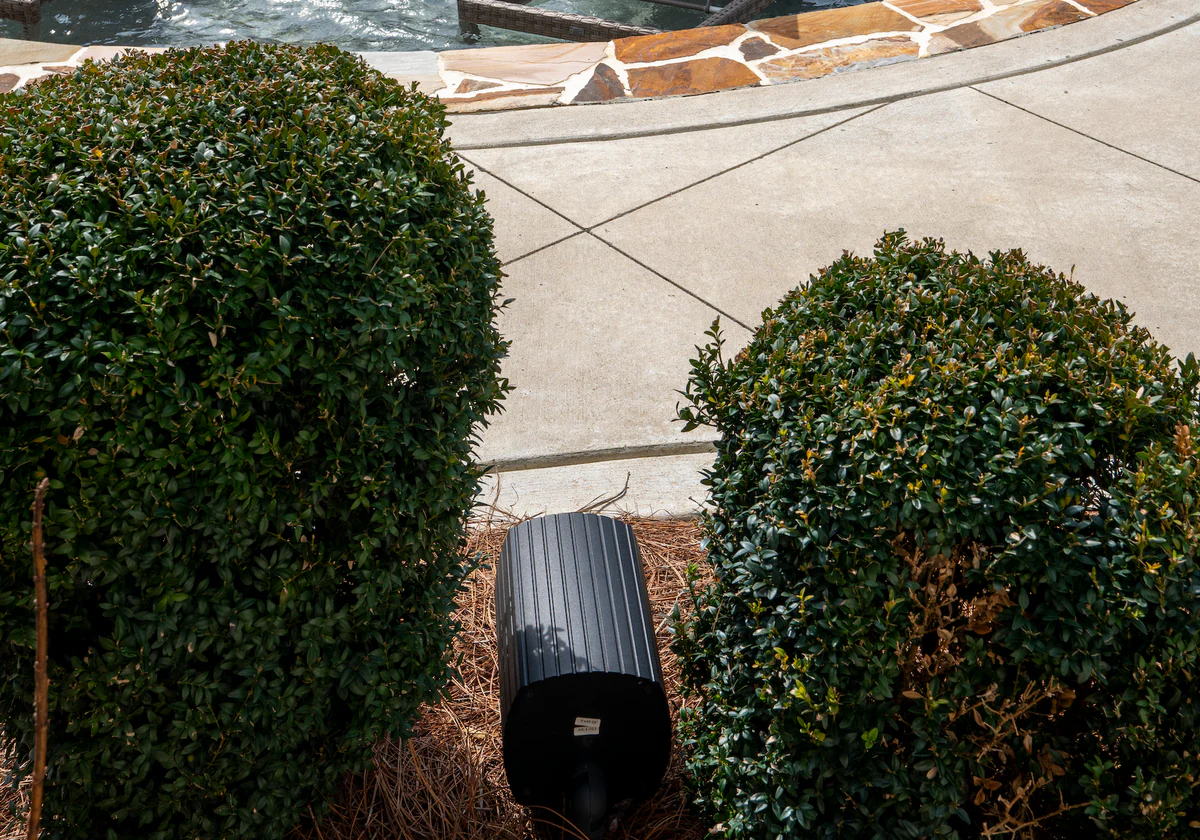 Outdoor dinner party with architectural audio