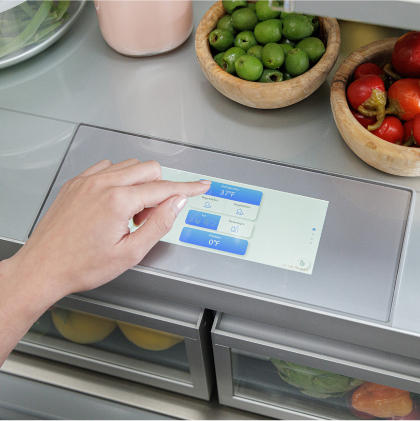 Thermador cooling system touchscreen control panel with hands adjusting temperature settings for optimal refrigeration