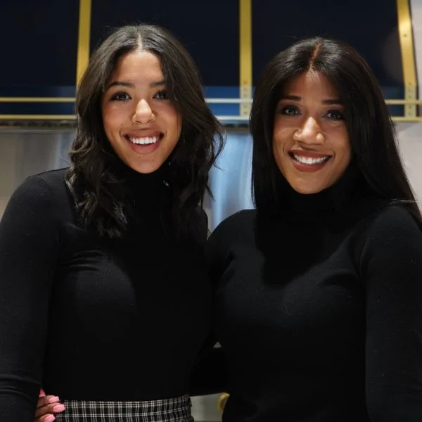 Nina and Shirley Hood beside each other in front of a black and gold range hood