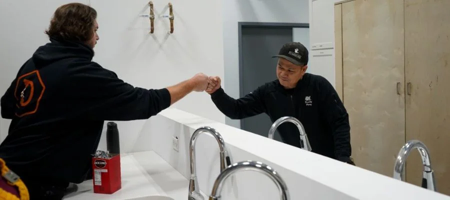 Freddy fist-bumping another employee in the training kitchen