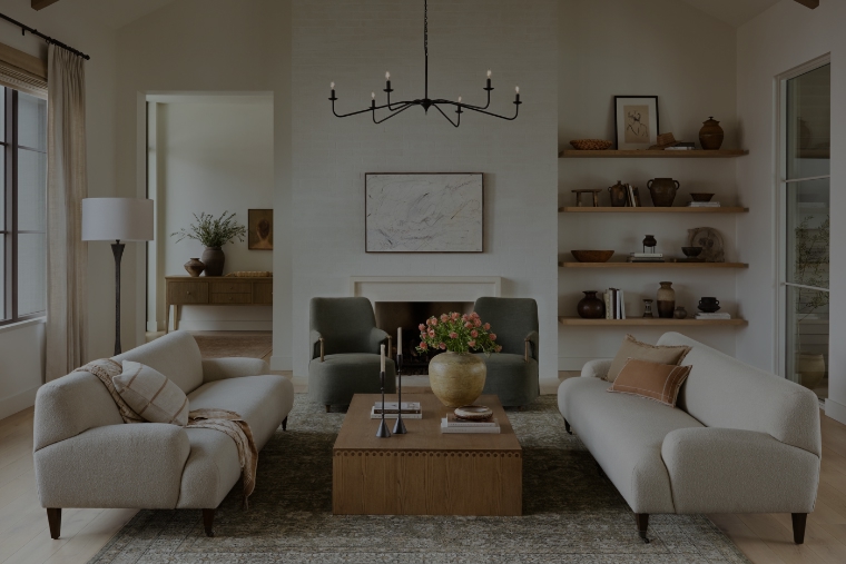 A cozy living room setting featuring various elements including mulitple living room furniture pieces and a mounted tv above a lit fireplace