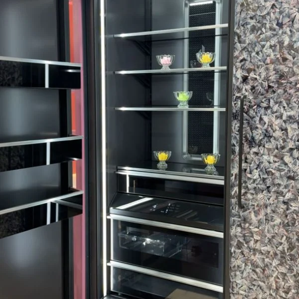 Closeup of JennAir refrigerator with Obsidian interior with food inside.