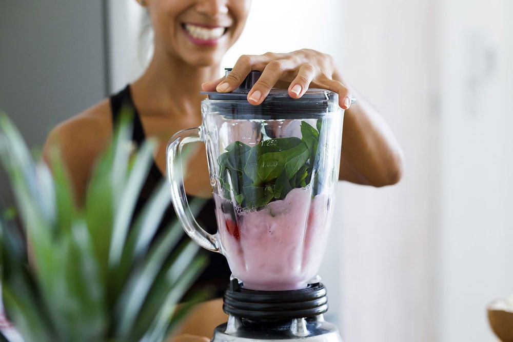 Person using blender to make nutrition drink