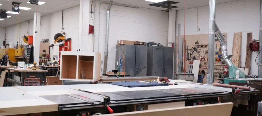 inside Abt's woodshop with tools and equipment on work tables