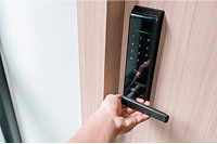 Person unlocking smart door lock using mobile-enabled key access