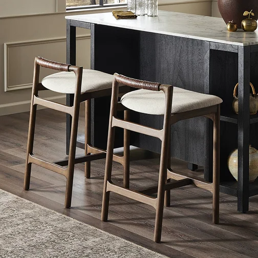 Two sleek bar stools placed in front of a contemporary kitchen island