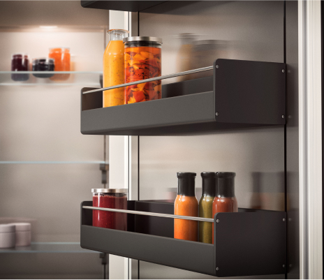 Detailed view of a Gaggenau refrigerator featuring shelves and a door, highlighting a storage accessory for improved space
