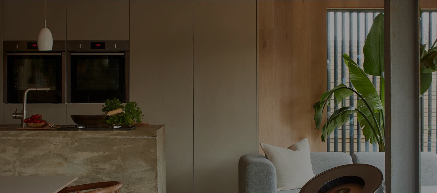 A simple kitchen layout showcasing a table and a chair, with various kitchen elements visible in the background.