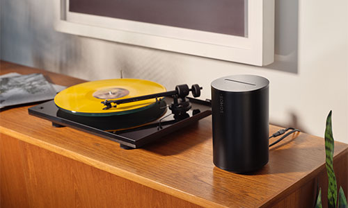 Sonos speaker next to a record player