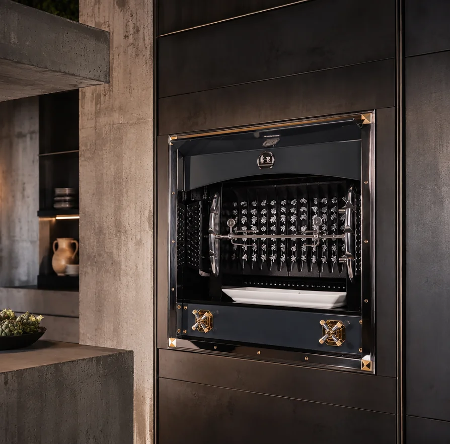 Black and gold La Cornue Flamberge rotisserie built into a dark paneled kitchen wall