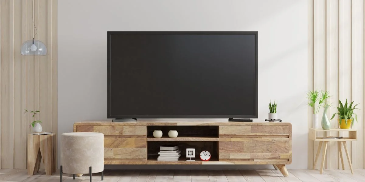 flat screen TV sitting on midcentury modern-style oak TV stand