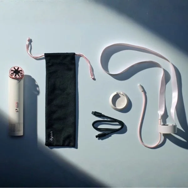 Flat lay of Dyson fan with the carrying pouch, neck strap and USB-C cord