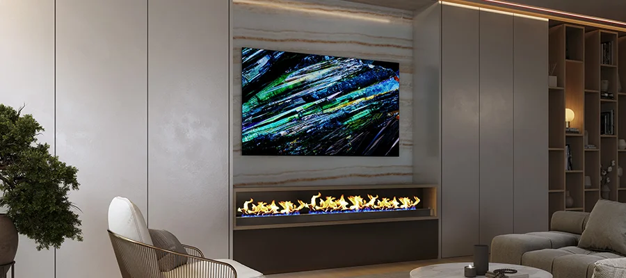 The Sony A95L mounted on a wall above a fireplace in a luxury living room