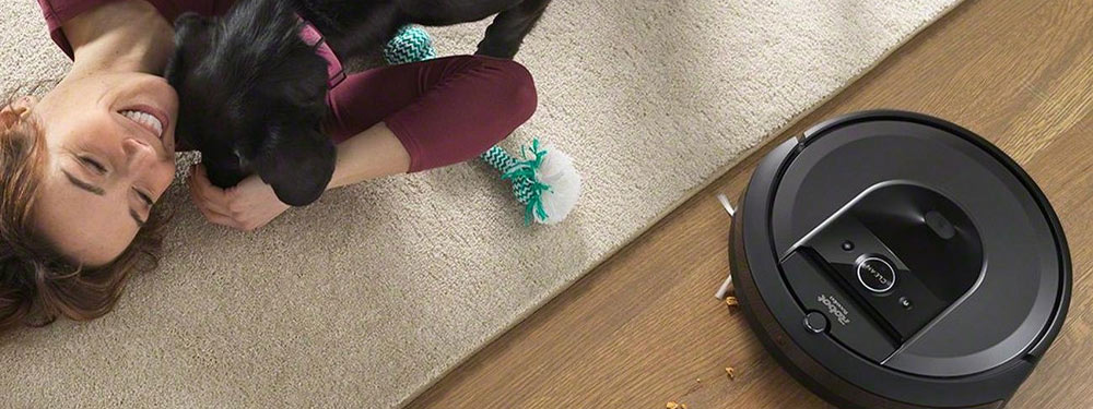 Person with dog next to robotic vacuum