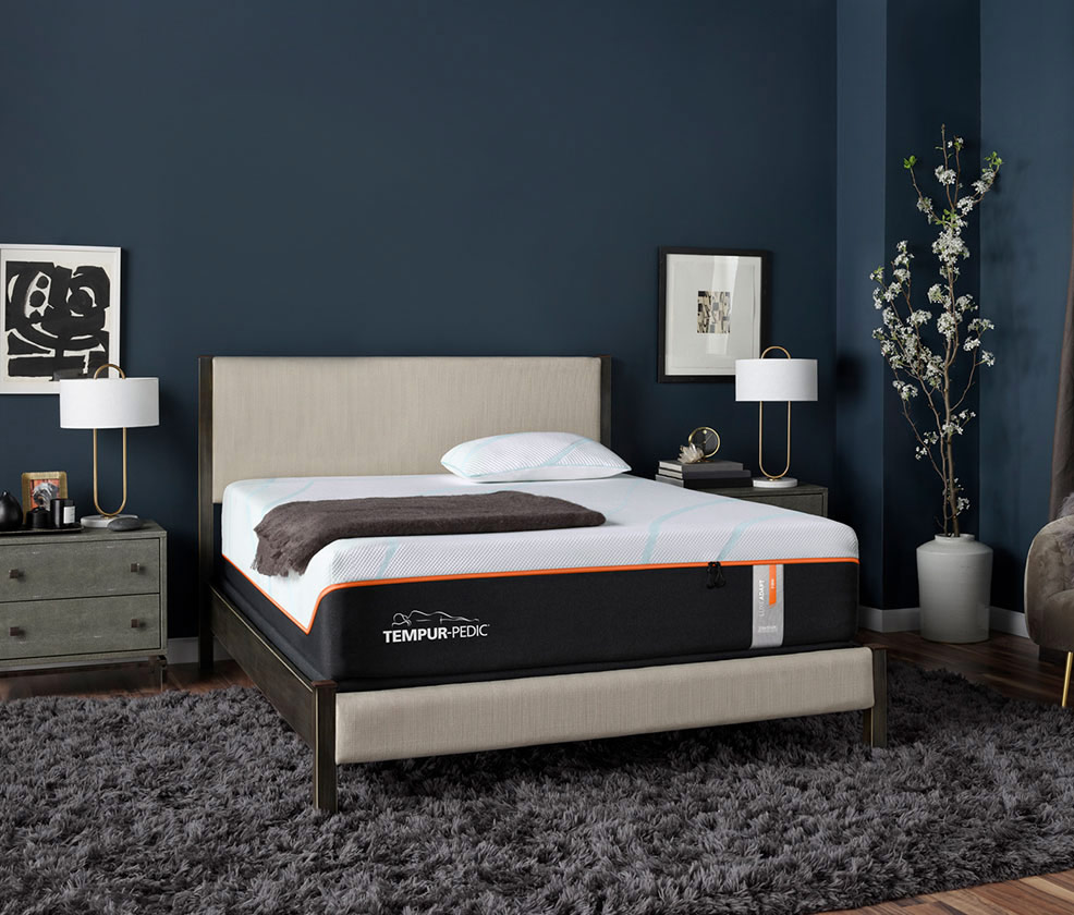 Tempur-Pedic bed and bedframe in a room with side tables