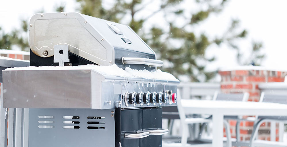 Grill outside covered in snow