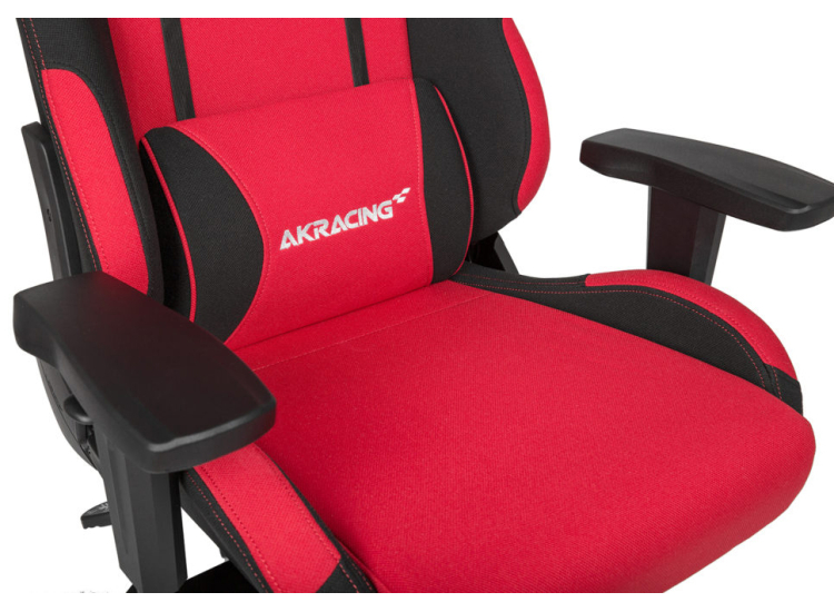 Close-up of red seat cushion with white AKRACING logo and black side panels.