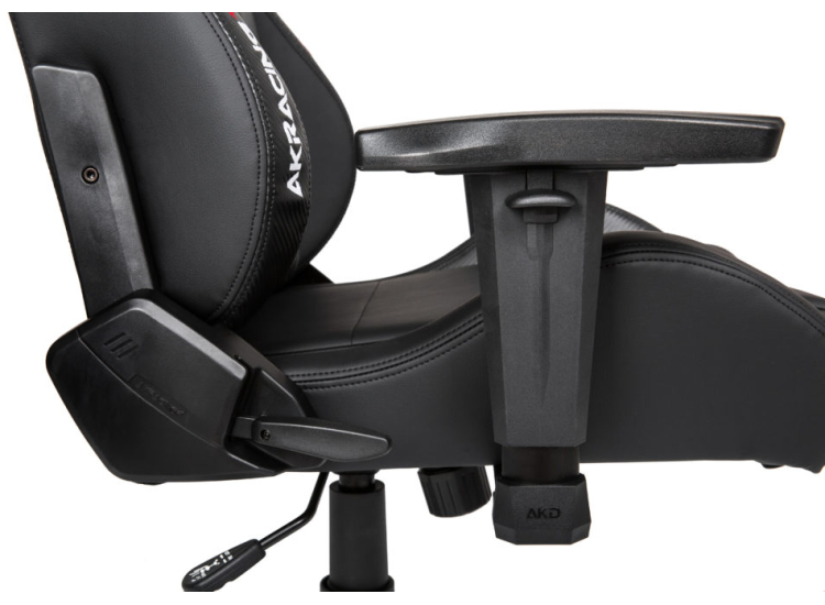 Side view of AKRACING gaming chair showing armrest, recline lever, and base with caster wheels.