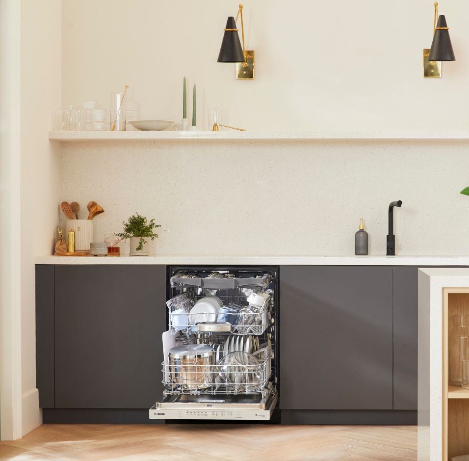 Modern kitchen featuring Thermador appliances, with picturesque mountain scenery visible through the large glass windows