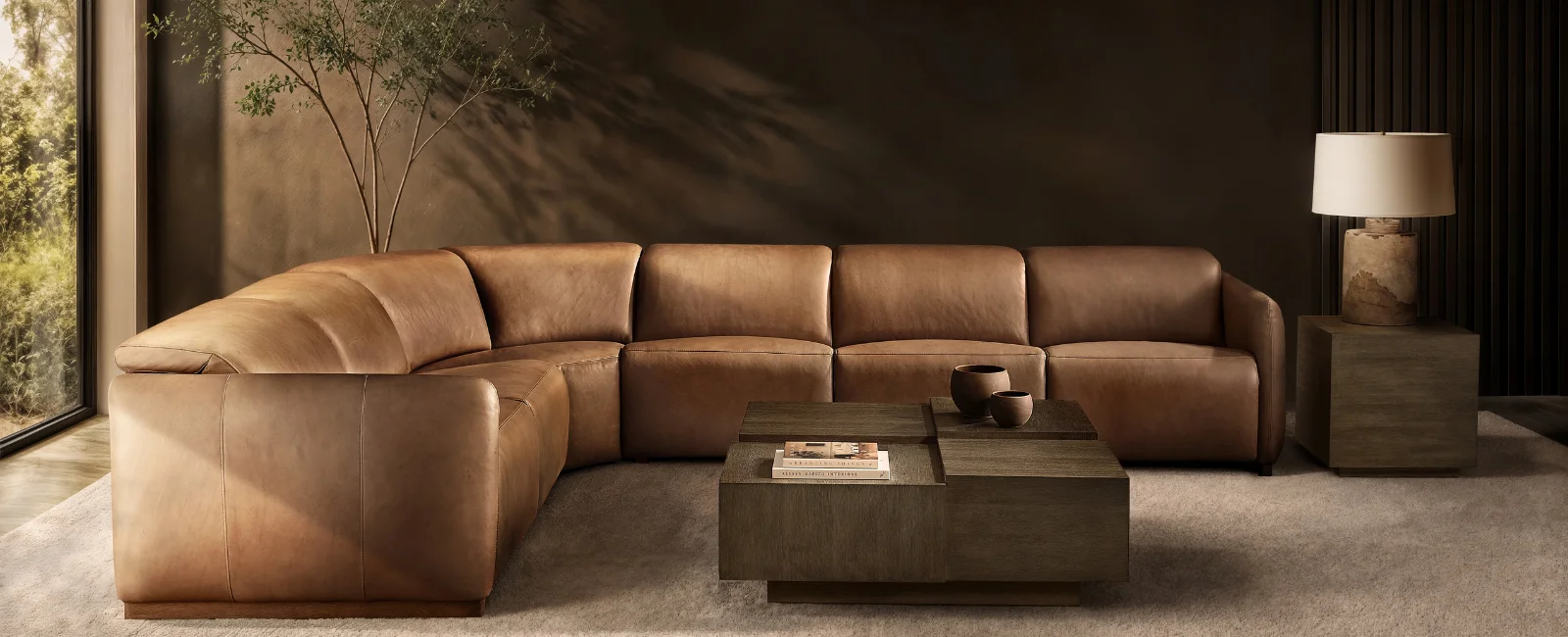 Spacious, stylish living room with a sofa, sectional and recliners arranged around a coffee table, styled for everyday living.